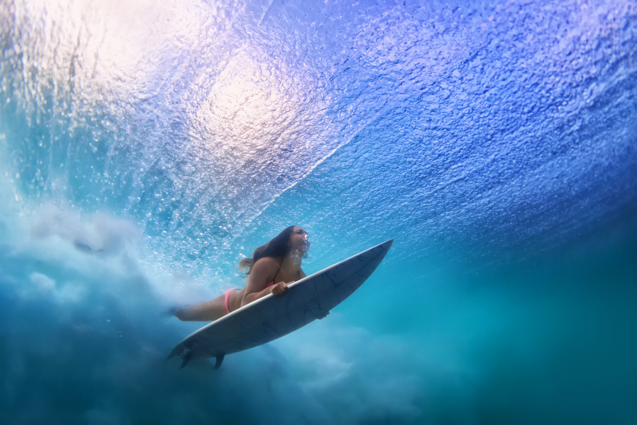 Surfer Duck Dives Under The Lip