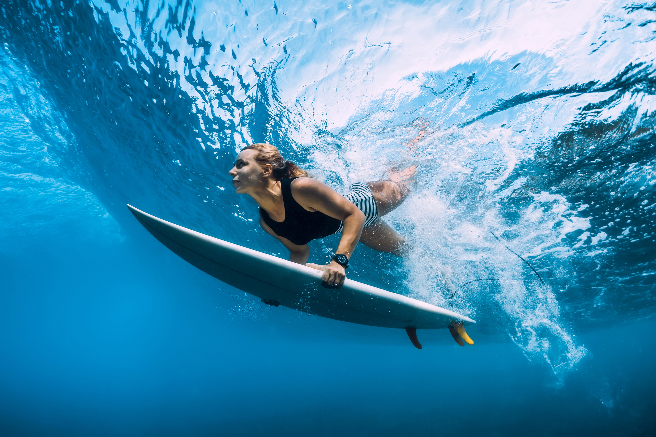 Surfer Duck Dives a Wave