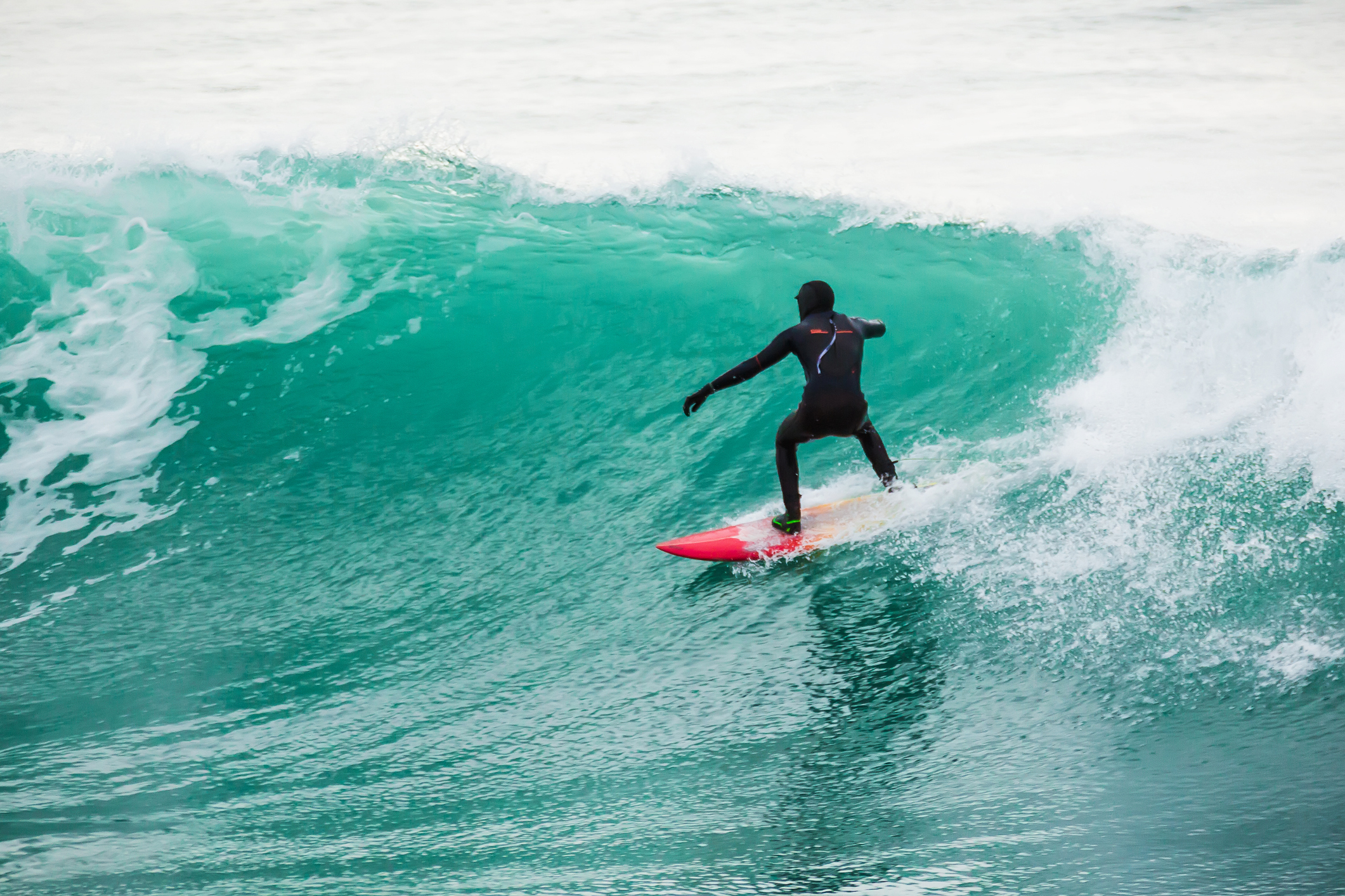 Surfing on turquoise wave in ocean