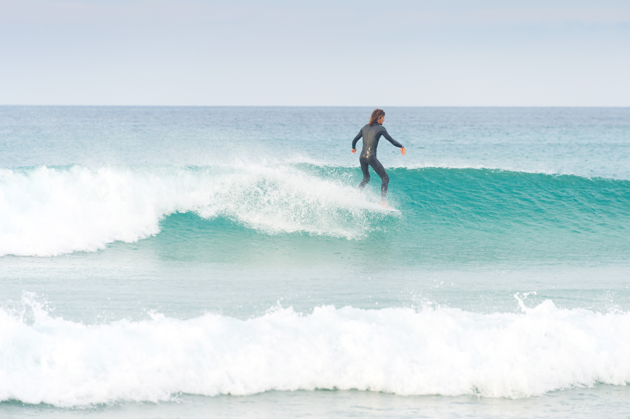 Hanging Five Toes over while surfing in Peniche